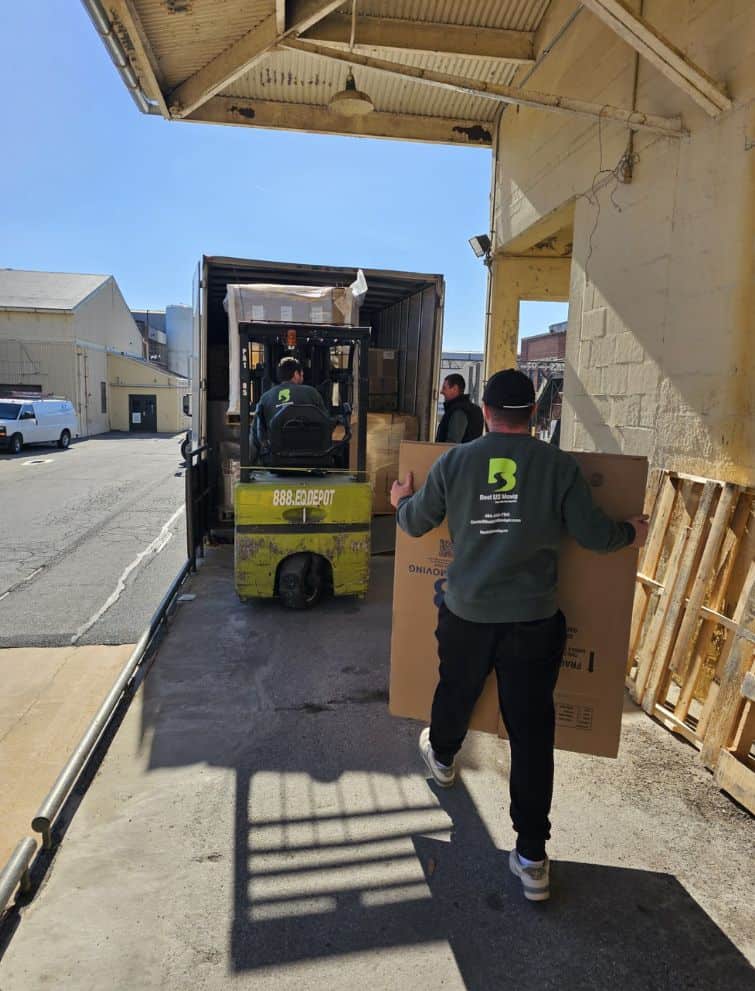 Moving crew loading boxes into a truck for US moving services.