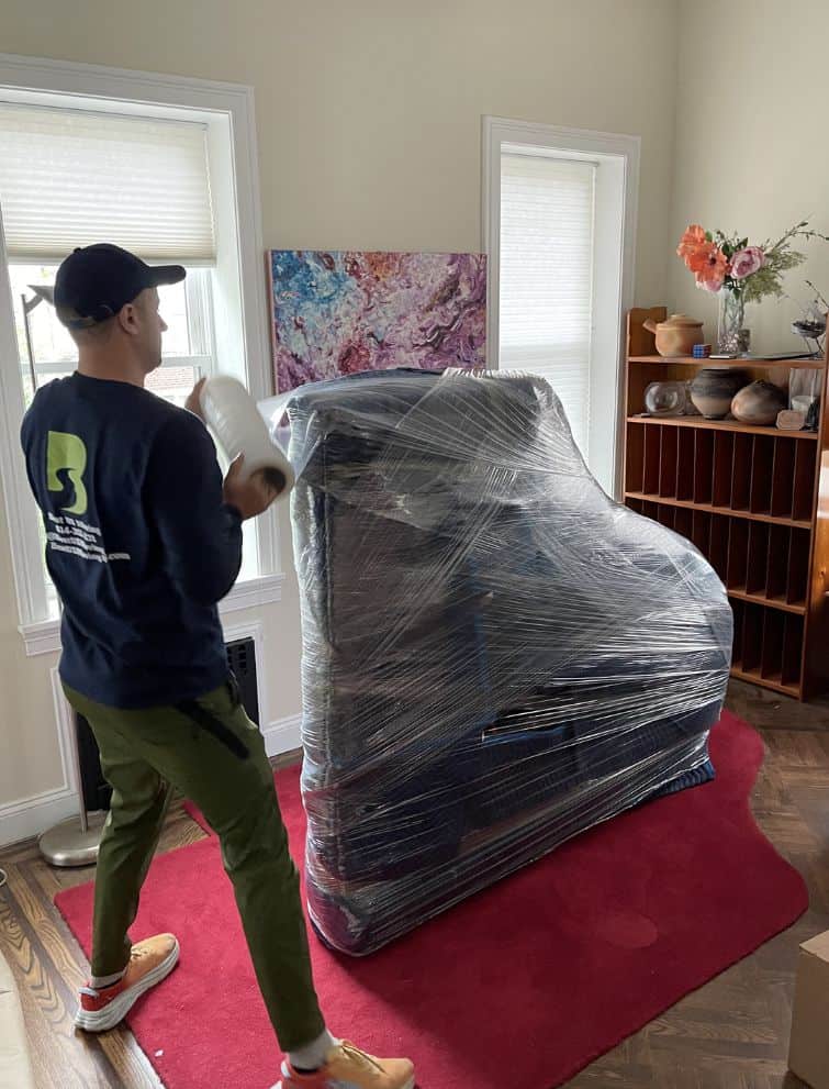 Professional piano moving service with wrapping for safe relocation in the US.