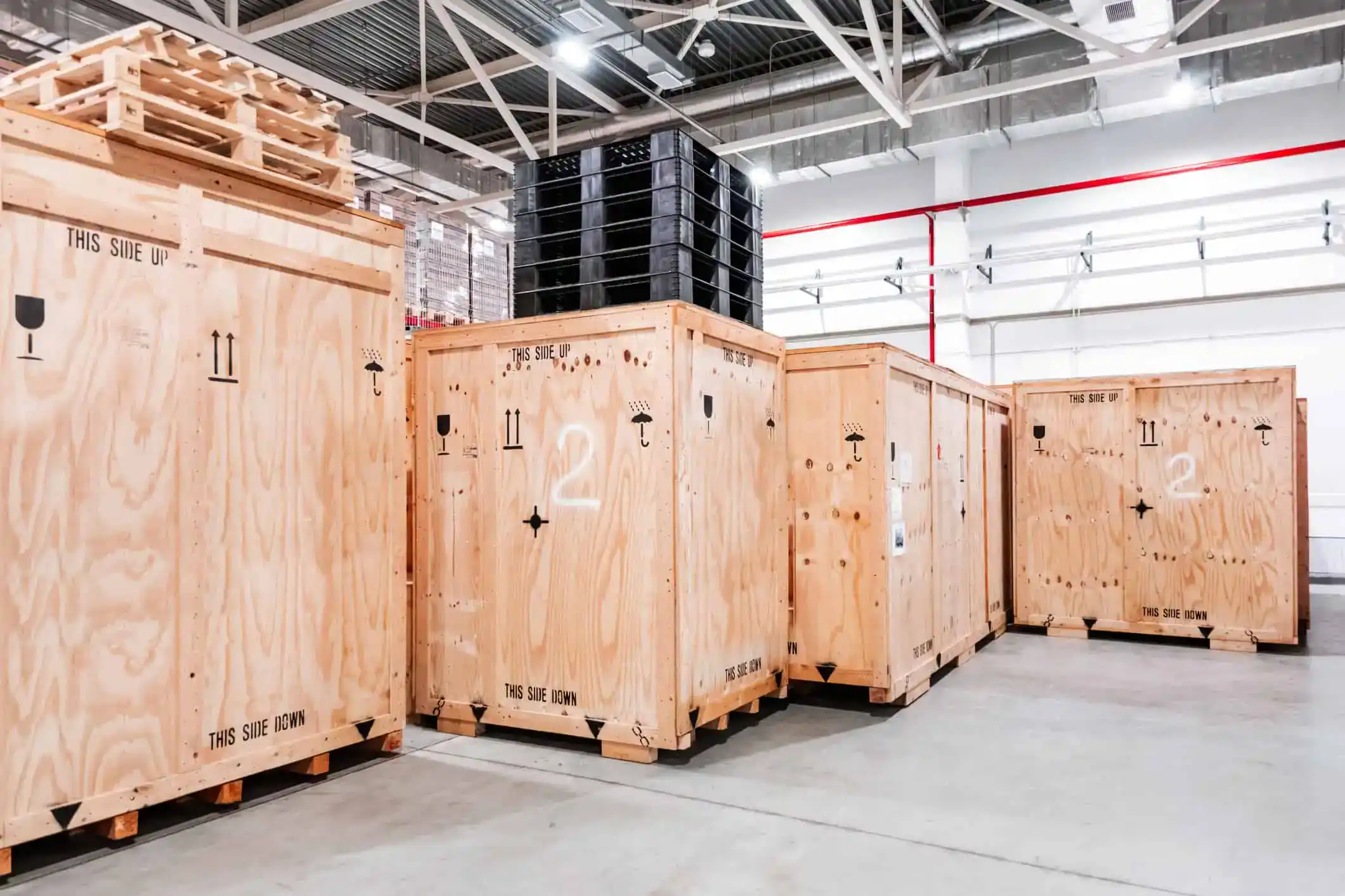 Moving crates and pallets in a warehouse for US relocation services.